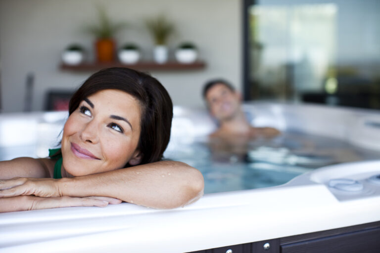 Woman and man relaxing in a Caldera hot tub